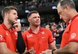 Sydney coach John Longmire (right) chats with an injured Luke Parker (left) and Taylor Adams. (Joel Carrett/AAP PHOTOS)
