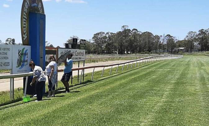 Kempsey Racing Club volunteers Michele Parsons, Gloria McGee and Philip Brett clean the signs ahead of the Kempsey Cup on Friday, November 4. Picture by Debbie Brett