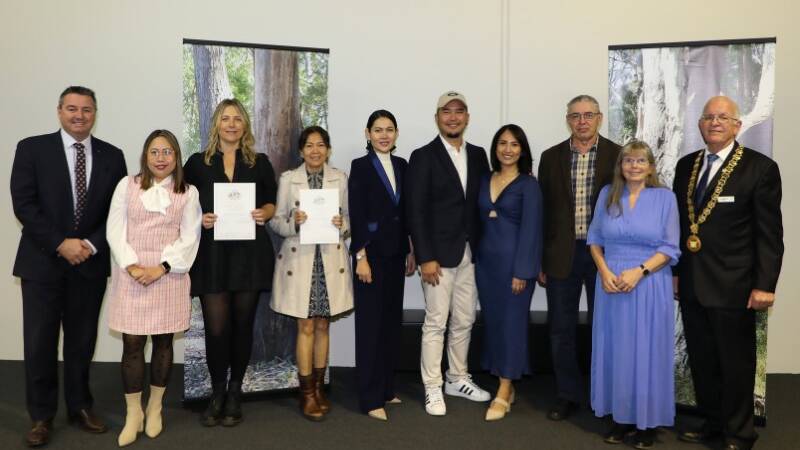 MP Member for Cowper Pat Conaghan and Kempsey Shire mayor Leo Hauville with the eight new Australian citizens. Picture supplied, Kempsey Shire Council 