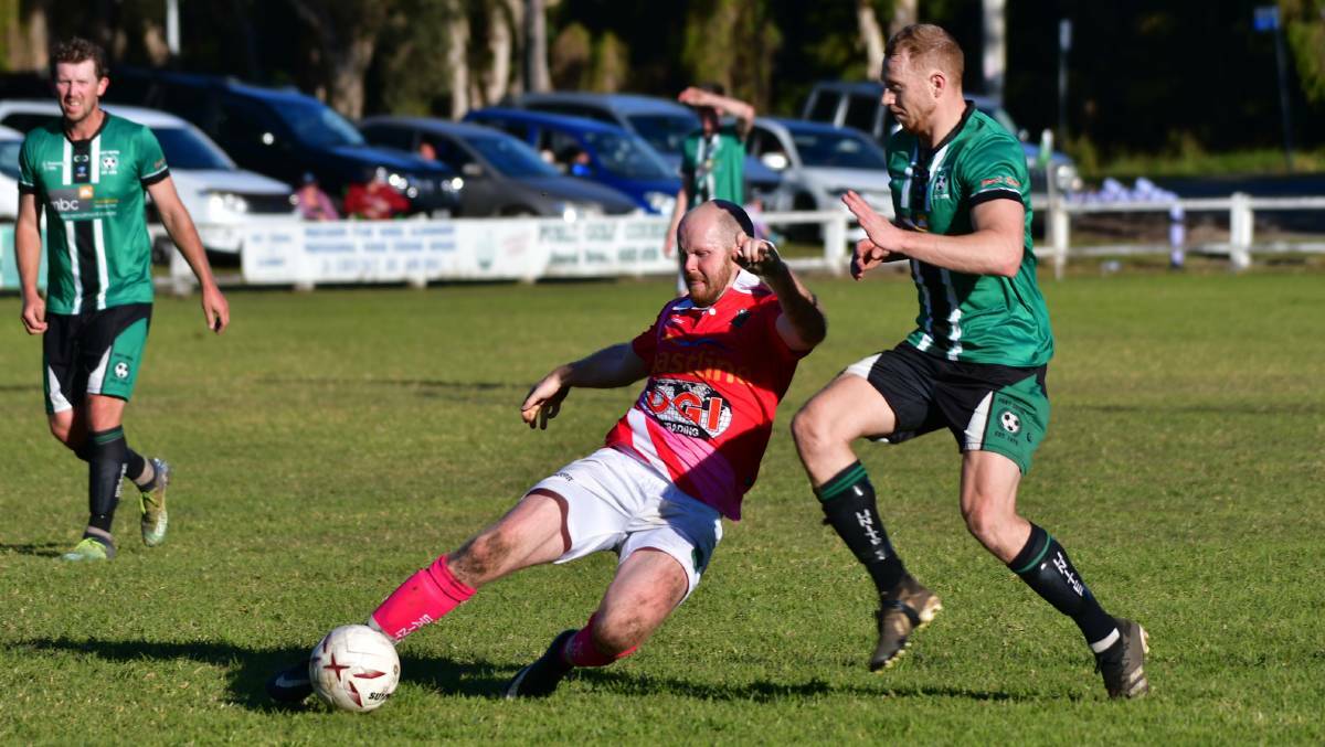 Kempsey Saints' co-coach Dan Baker clears the ball from Port United's Josh Casey during their June 2022 CPL clash. File picture by Paul Jobber