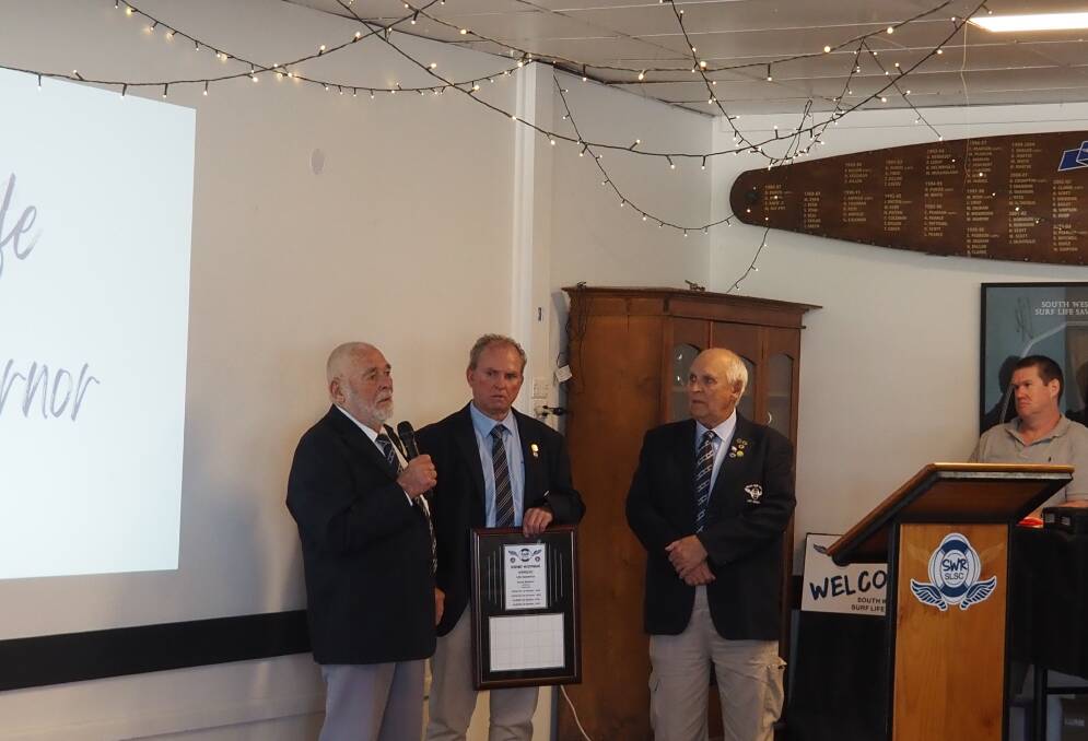 Current Life Governors Tony Hayes OAM and Bruce Caldwell present Rod McDonagh with the award to join them as Life Governor on June 2. Picture supplied SWRSLSC