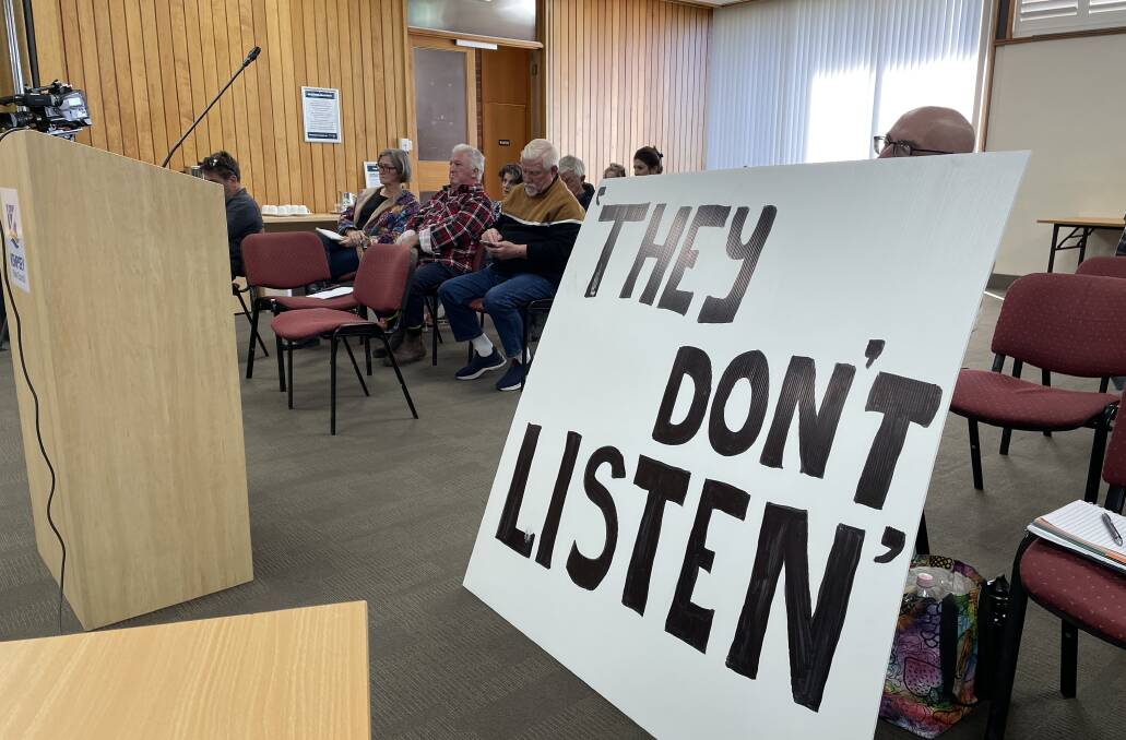 Community members gather in the public gallery on Tuesday, June 18, to hear the decisions made at the Council Ordinary Meeting. Lindsay Keay sits behind his sign as a response to the rate rise. Picture by Ellie Chamberlain