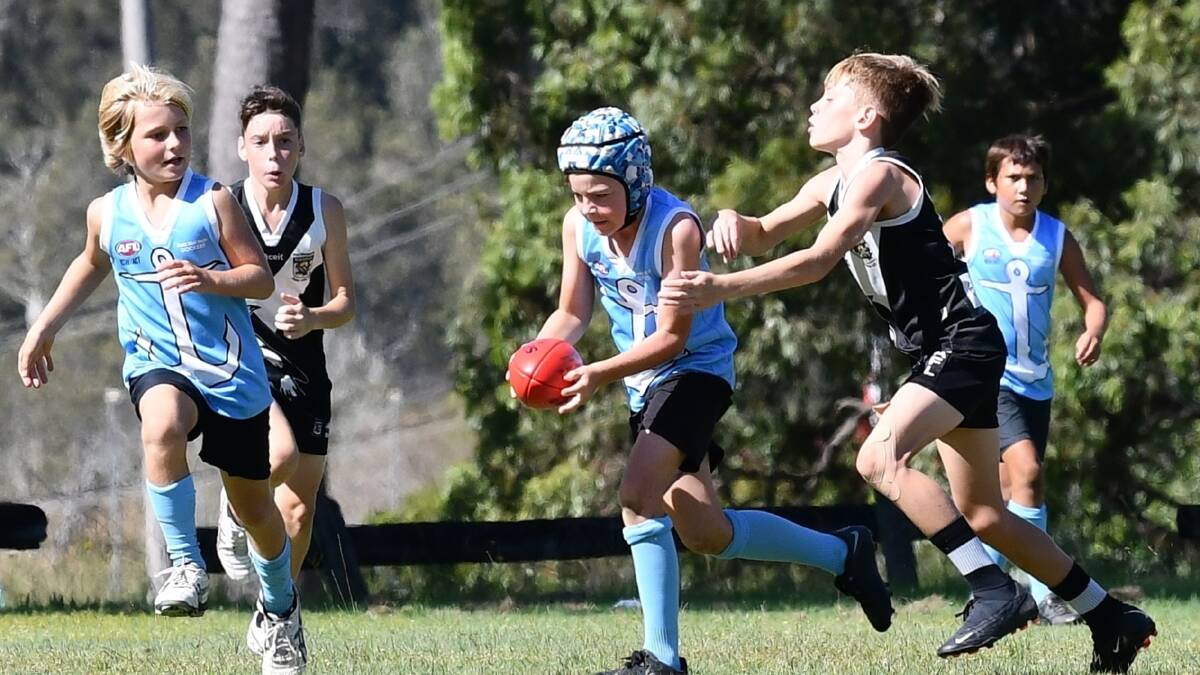 Instead of playing their home ground at South West Rocks, Dockers under 12s were moved to South Kempsey to play Port Macquarie Swoopers. Pictures by Penny Tamblyn