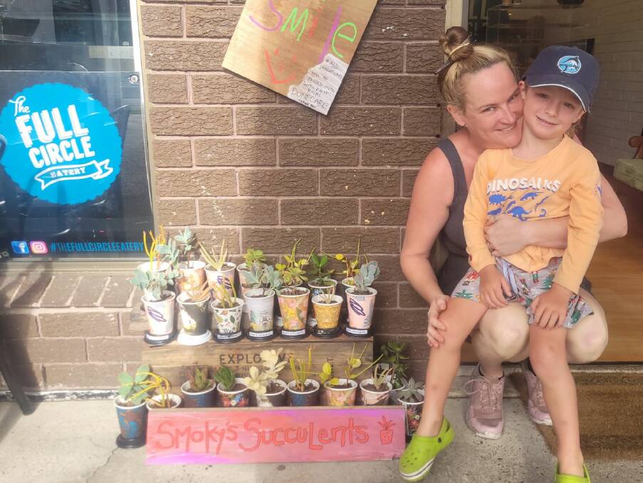 Four-and-a-half-year-old Owen Gaddes and cafe owner Krystal Hennessy show off the succulents that have been collecting donations for South West Rocks Dune Care to help save South Smoky. Picture supplied/ Taryn de Luca.