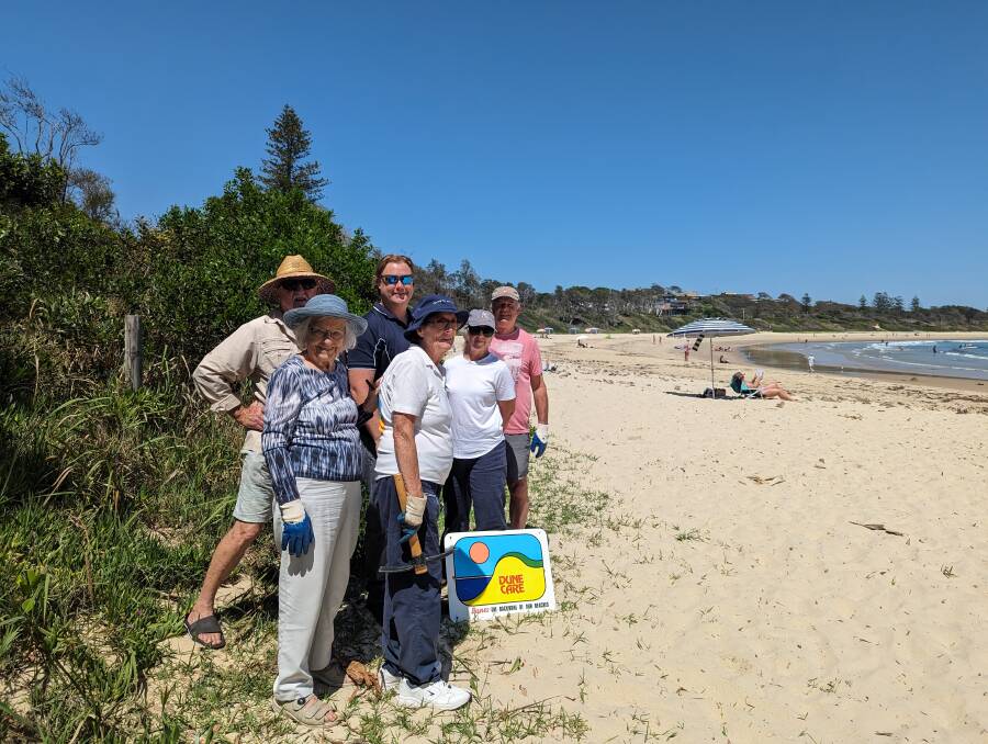 Members of Scotts Head Dunecare with Reflections regional manager Scott Burns (centre). Picture supplied / Reflections Holidays