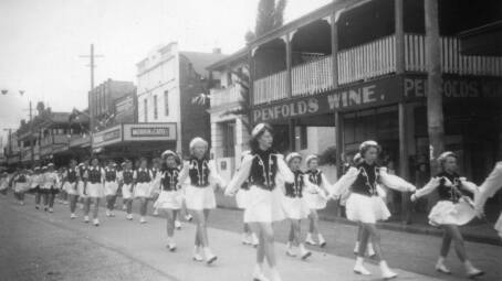 Marching Girls in a procession through Smith street, Kempsey in the 1950s. Picture: Audrey Partridge Collection