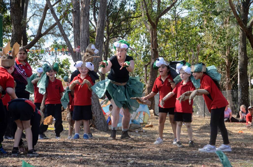 Polyglot Theatre artists Tamara Rewse with Kempsey South Public School students protecting the sacred seed in their school performance. Picture by Emily Walker 