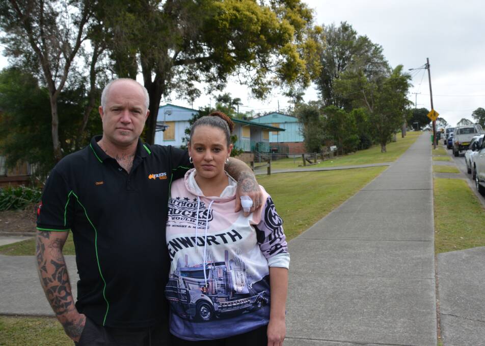 Craig Dates and Lauren Blogg stand outside public housing that has since been boarded up. Photo: Emily Walker