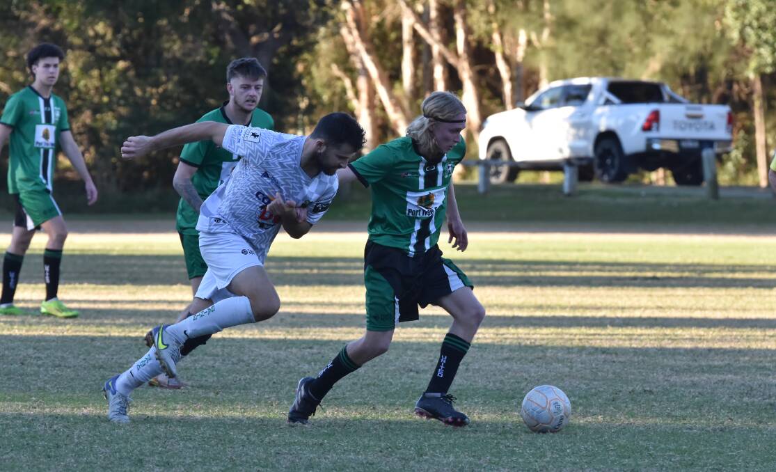 Kempsey Saint's Evan Clarke and Port United's Chester Wade battle for the ball. Picture by Emily Walker