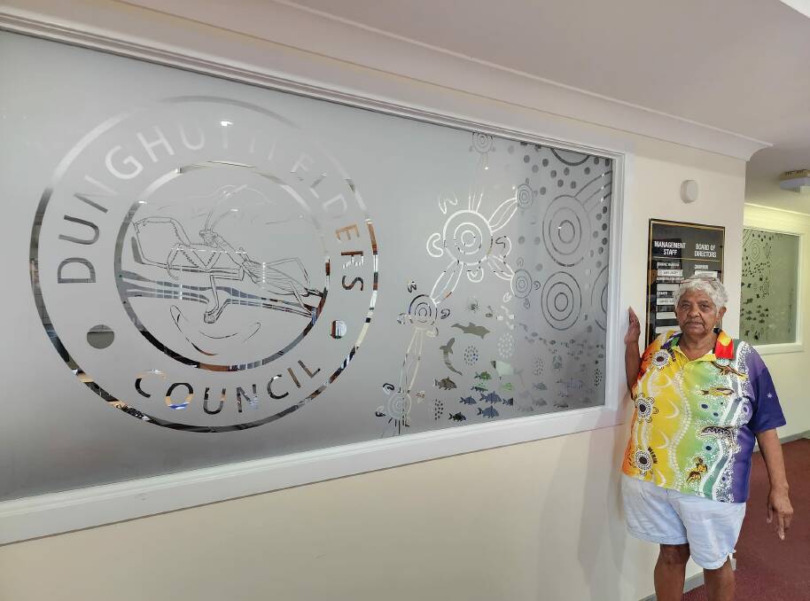 Aunty Carmel Vale stands beside the new frosted privacy glass installed at the Dunghutti Elders Council. Picture supplied by Dunghutti Elders Council Aborginal Corporation