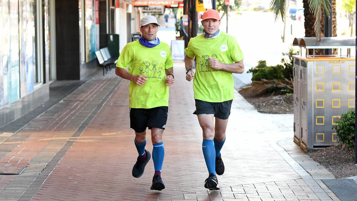 Wayne Curran and Pat Farmer stop in Taree on their multi-day run for a reason. Pictures by Scott Calvin