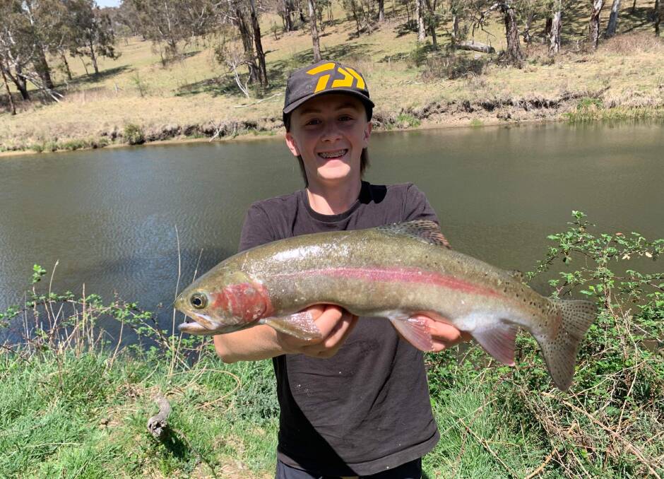 Olly Henry and his dad David ventured west during the school holidays and had a fantastic time catching trout on a property near Armidale. Picture supplied. 