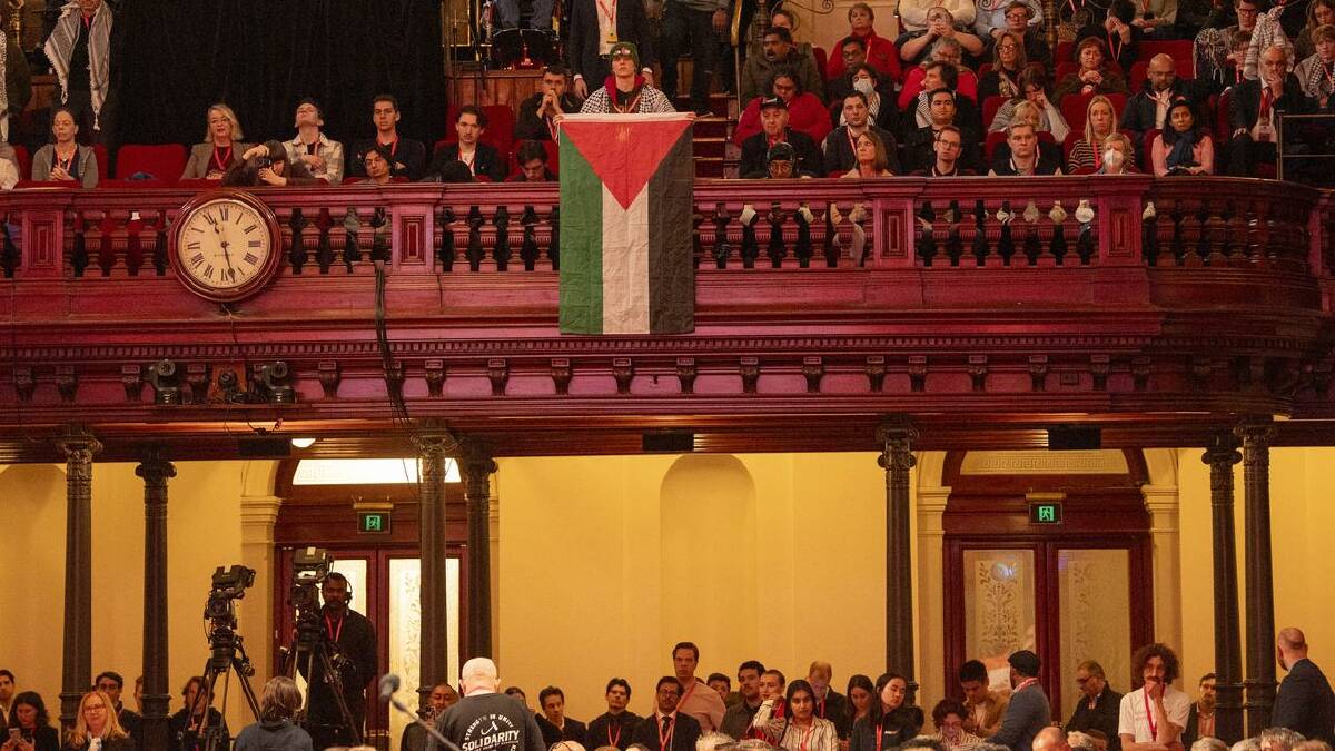 A delegate unfurled a Palestinian flag during the prime minister's speech. (Jeremy Piper/AAP PHOTOS)