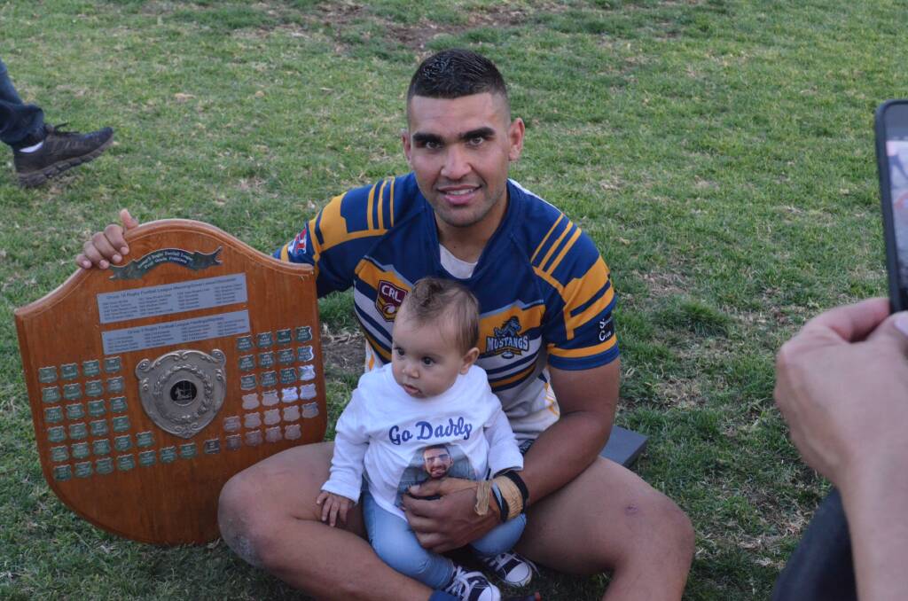 Richie Roberts with baby Zhade and the Group Three premiership trophy. Photo: Callum McGregor