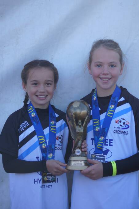 Champions: Chelsea Hackenberg and Ava Ryan helped lead their Under-12 Football Mid North Coast representative side to victory. Photo: Supplied.